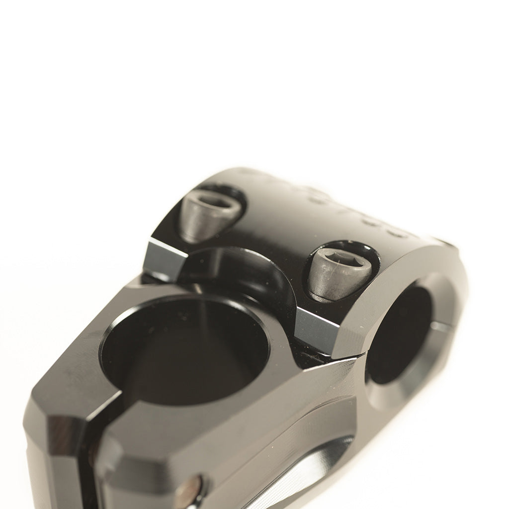 A close up image of a Colony Variant 35mm BMX Stem, a low-rise alternative in the form of a black bicycle stem.
