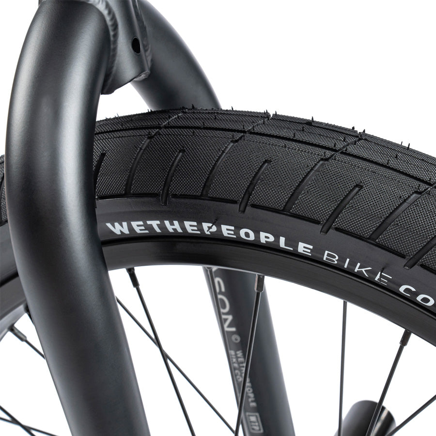 A close up of a Wethepeople Reason 20 Inch BMX Bike tire, specifically the black tire on a Wethepeople Reason model.