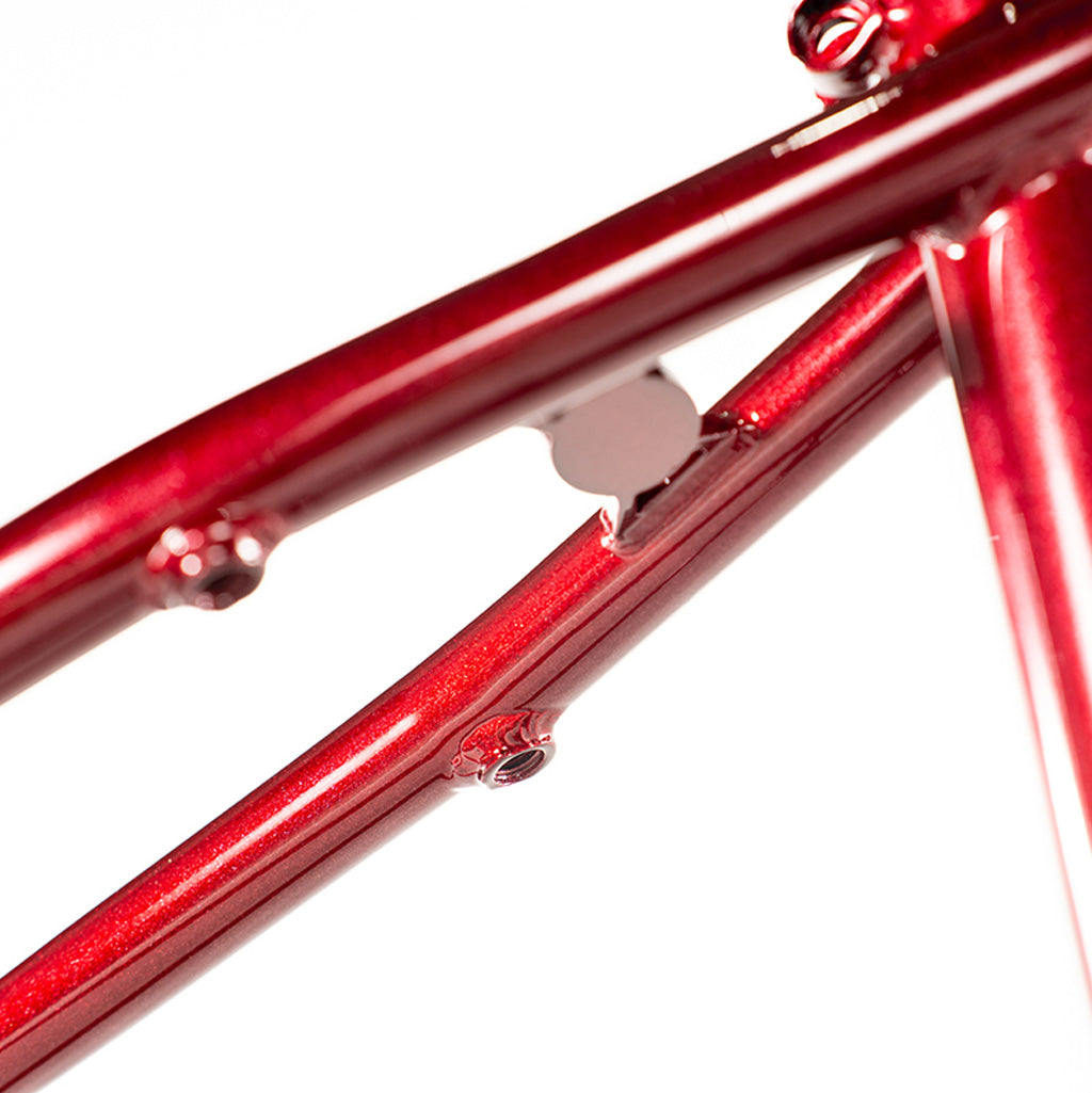 A close up of the Colony Rico 'Lite' Frame, a red bicycle frame expertly designed by Paterico Fallico, the technical wizard.