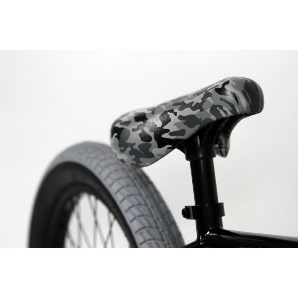 Close-up of the Black Eye Commando 20 Inch Bike (2022) rear wheel and gray camouflage seat; features a light gray tire—ideal for entry-level BMX riders.