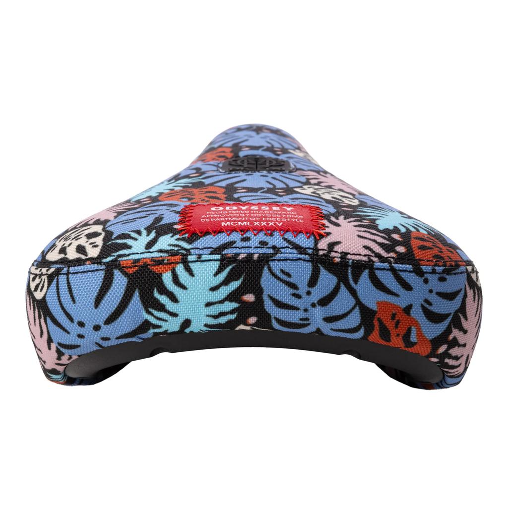 The Odyssey Tropical V1 Pivotal Seat sports sublimated tropical leaf artwork in blue, pink, orange, and black, finished with a stitched red label for vibrant style and island vibes.