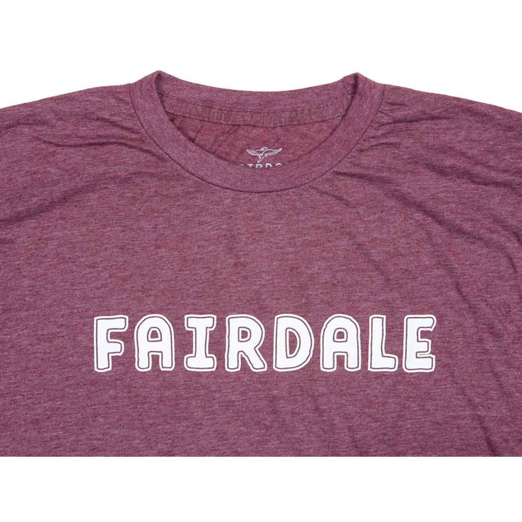 The Fairdale Outline T-Shirt features "FAIRDALE" in bold, white outlined letters across the chest—a maroon tee perfect for parties or showing support along the Fall line.
