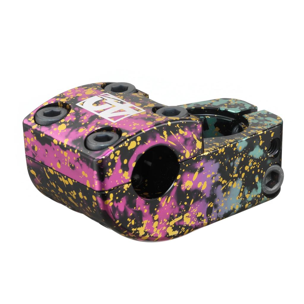 The Odyssey Nord Stem (40th Anniversary) is a limited edition BMX stem with a pink, black, green, and yellow splatter paint design and four visible bolts, inspired by the Matt Nordstrom signature Odyssey Nord stem.