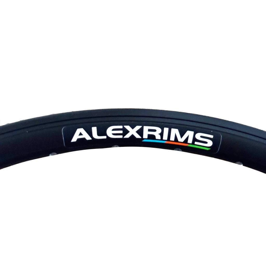 A close-up of a black Alex DA22 Rim, 20" with an aero profile, featuring the "ALEXRIMS" brand name and a small multicolored stripe.