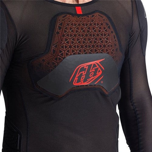 Person wearing the TLD 26.1 Stage Ghost D30 LS Protective Shirt Baselayer, a black mesh top from the base layer collection, featuring a geometric chest plate with red logo and advanced underlayer protection system.