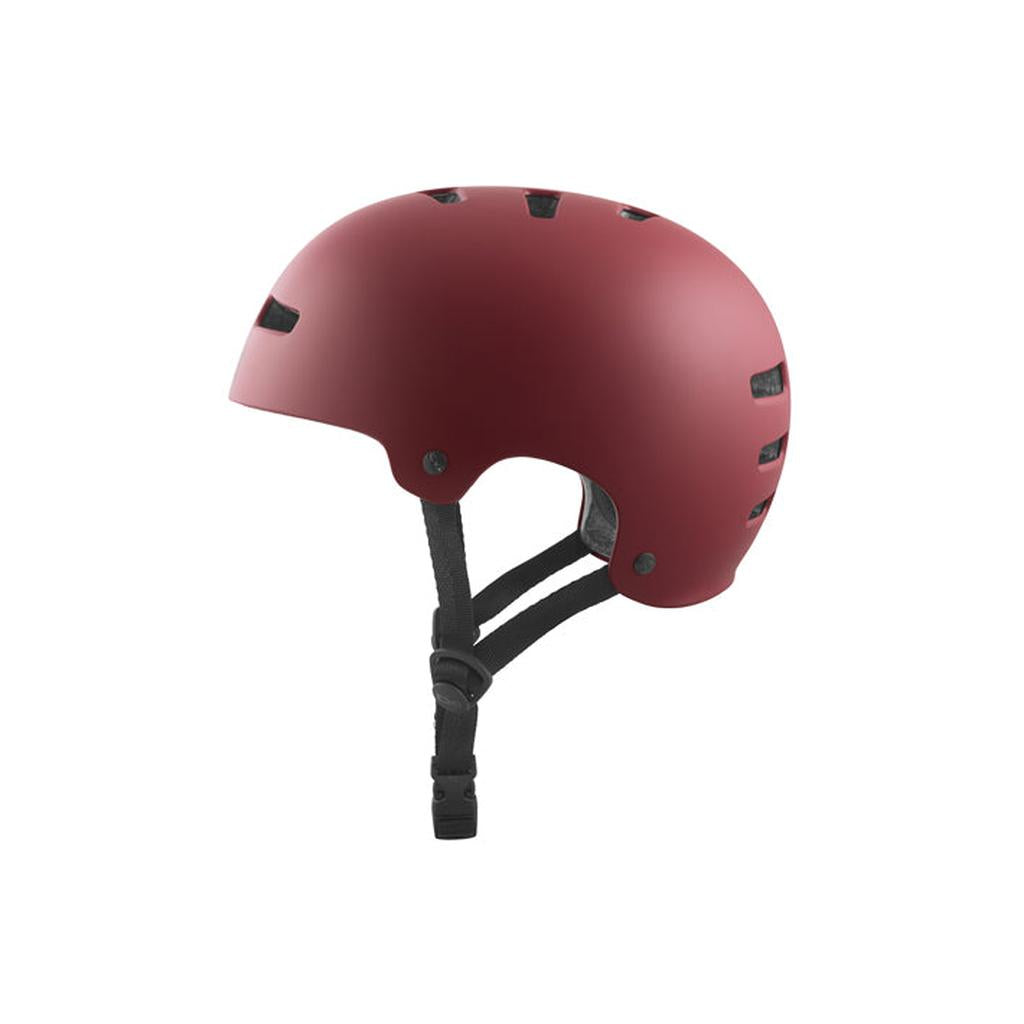 The TSG Evolution Helmet in Satin Oxblood features a slim hardshell design, high-impact protection, black adjustable straps, side ventilation holes, and a simple rounded profile for comfortable safety while skateboarding or biking.