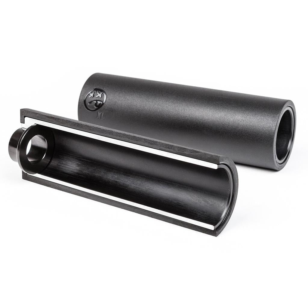 A cylindrical black metal tube—one whole, one cut open to show the hollow inside—resembles the BSD Rude Tube LT V2 Plastic Peg (Each), known for its lightweight BMX peg design.