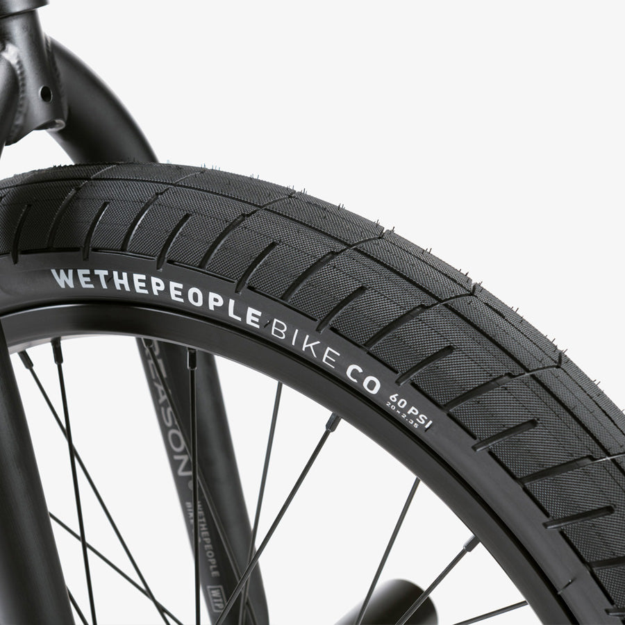 A close up of a bike tire of the Wethepeople Reason 20 Inch BMX Bike, designed for urban warriors.