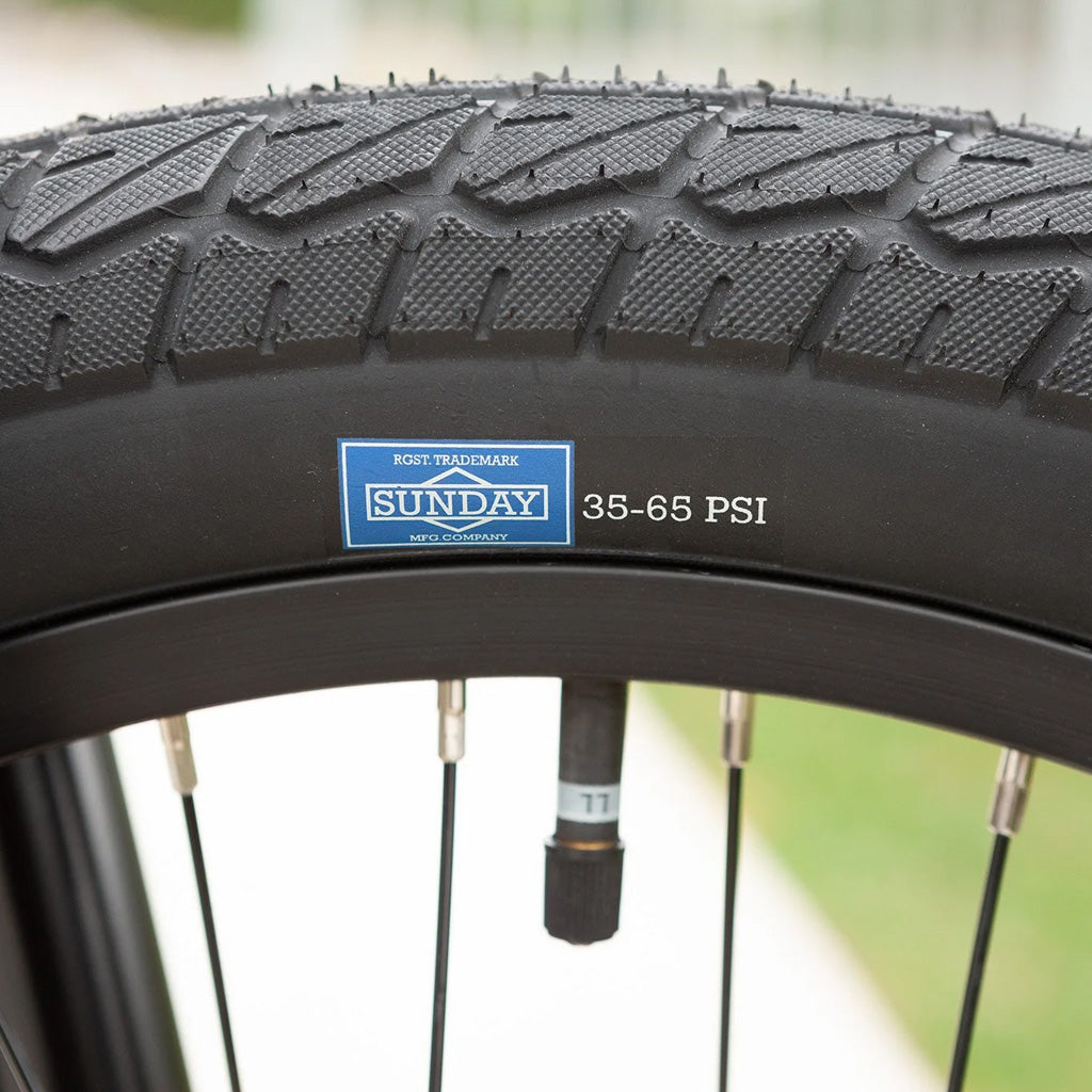 A close up of a Sunday Blueprint 20 inch Bike with a label on it.