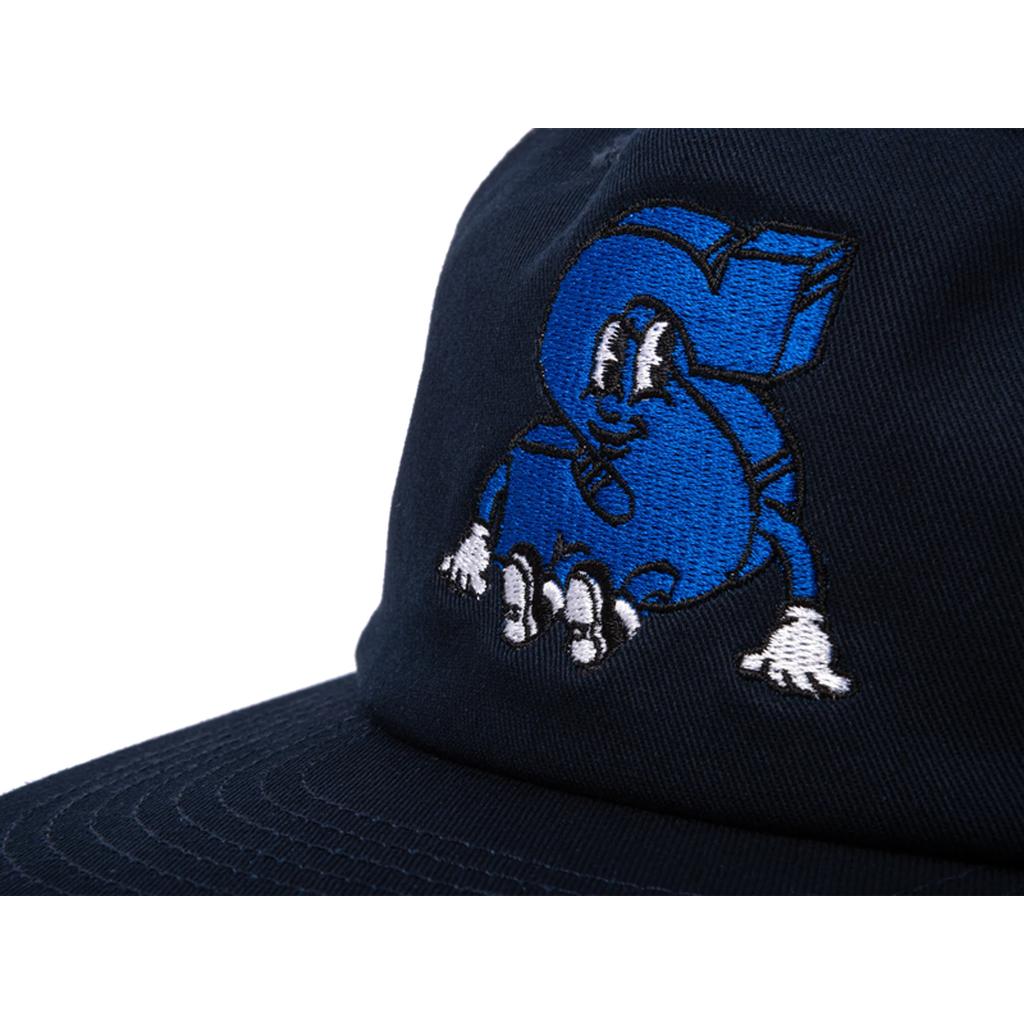 The Sunday S Man Unstructured Cap is a navy blue dome cap with an embroidered blue cartoon "S" sporting white gloves, shoes, and a smiling face—a fun new look from our Sunday caps collection.
