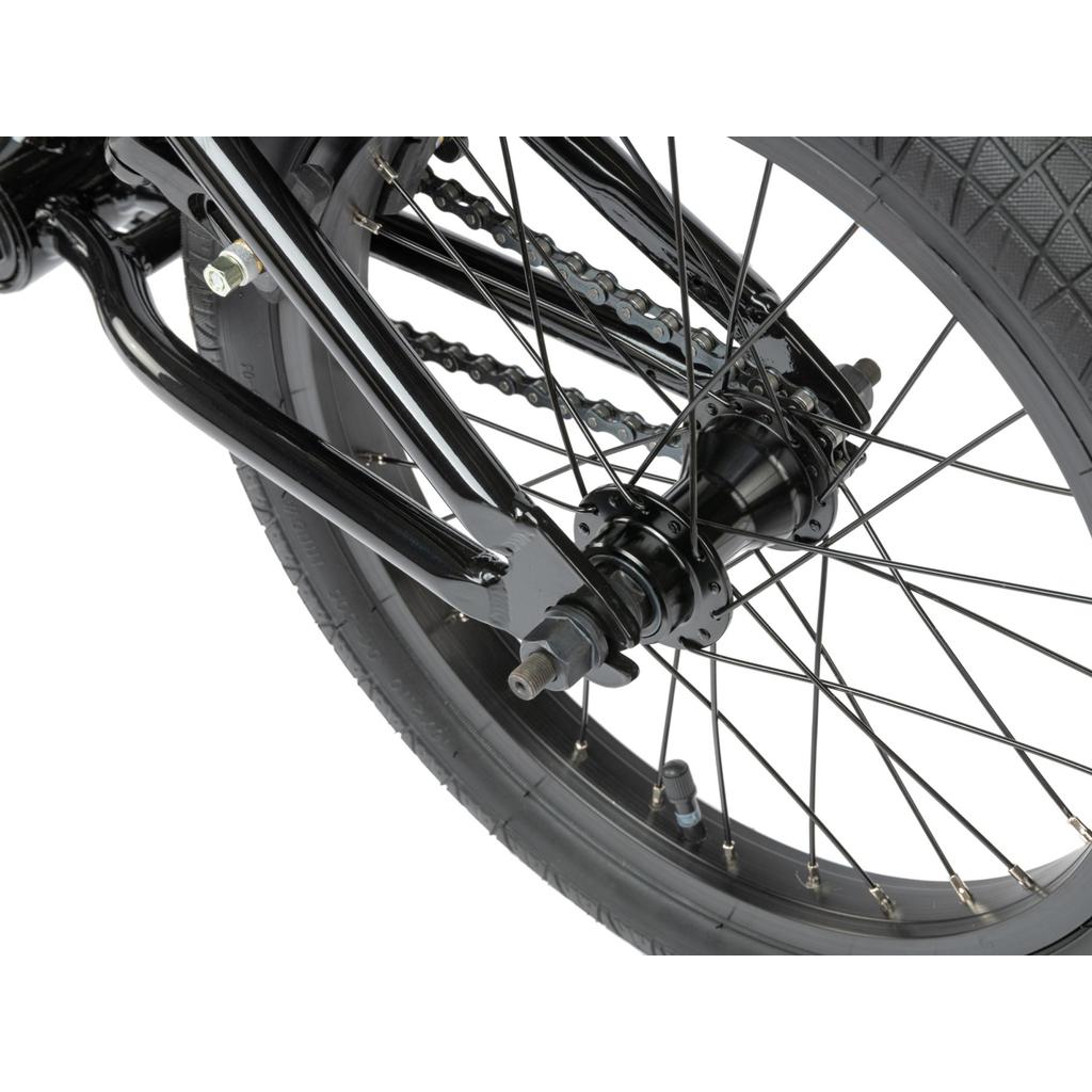 Close-up view of the Radio Revo 16 Inch Bike’s rear wheel, displaying the hub, spokes, chain, and part of the frame.