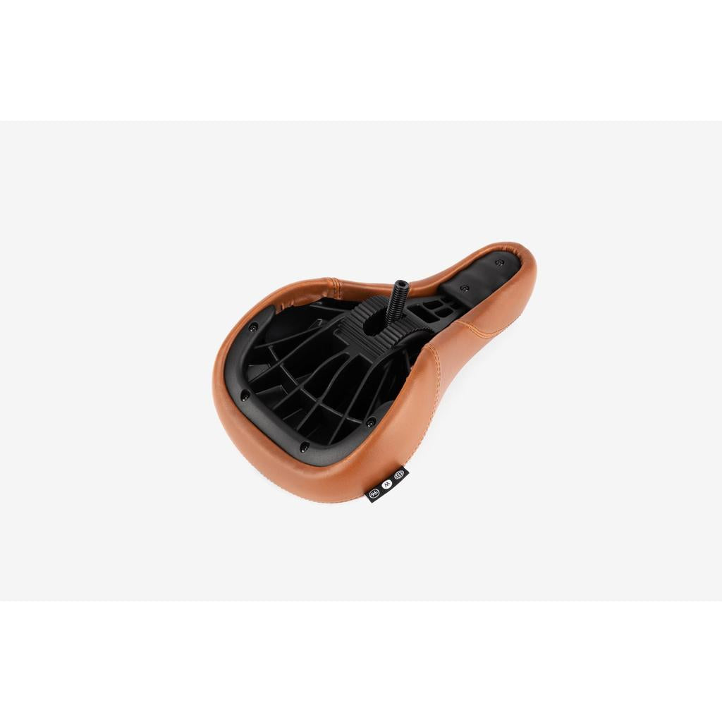 The Wethepeople Team Pivotal Fat Seat, in brown and black, is shown from below, highlighting its underside structure and mounting bolt.