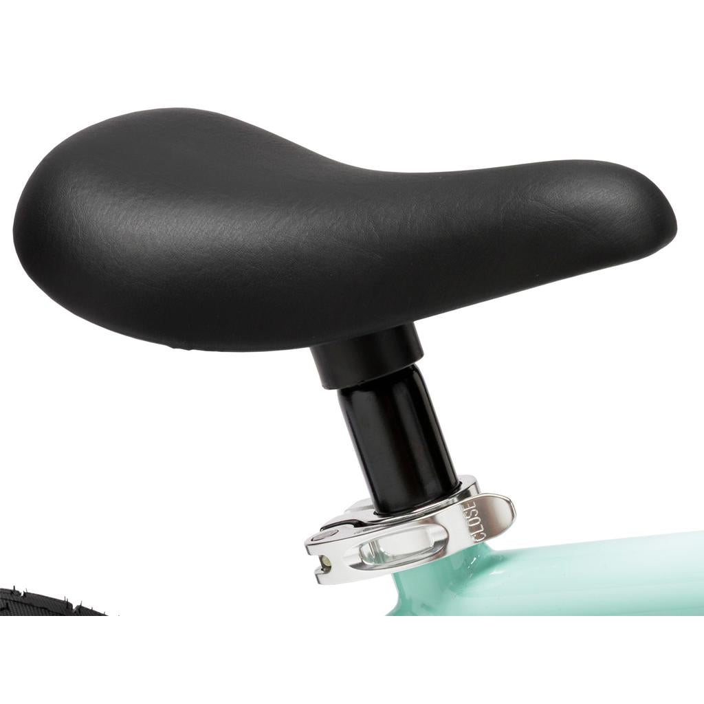 Close-up of a black seat with quick-release clamp on the Fit Misfit 12 Inch Bike, a light blue kids pedal bike.