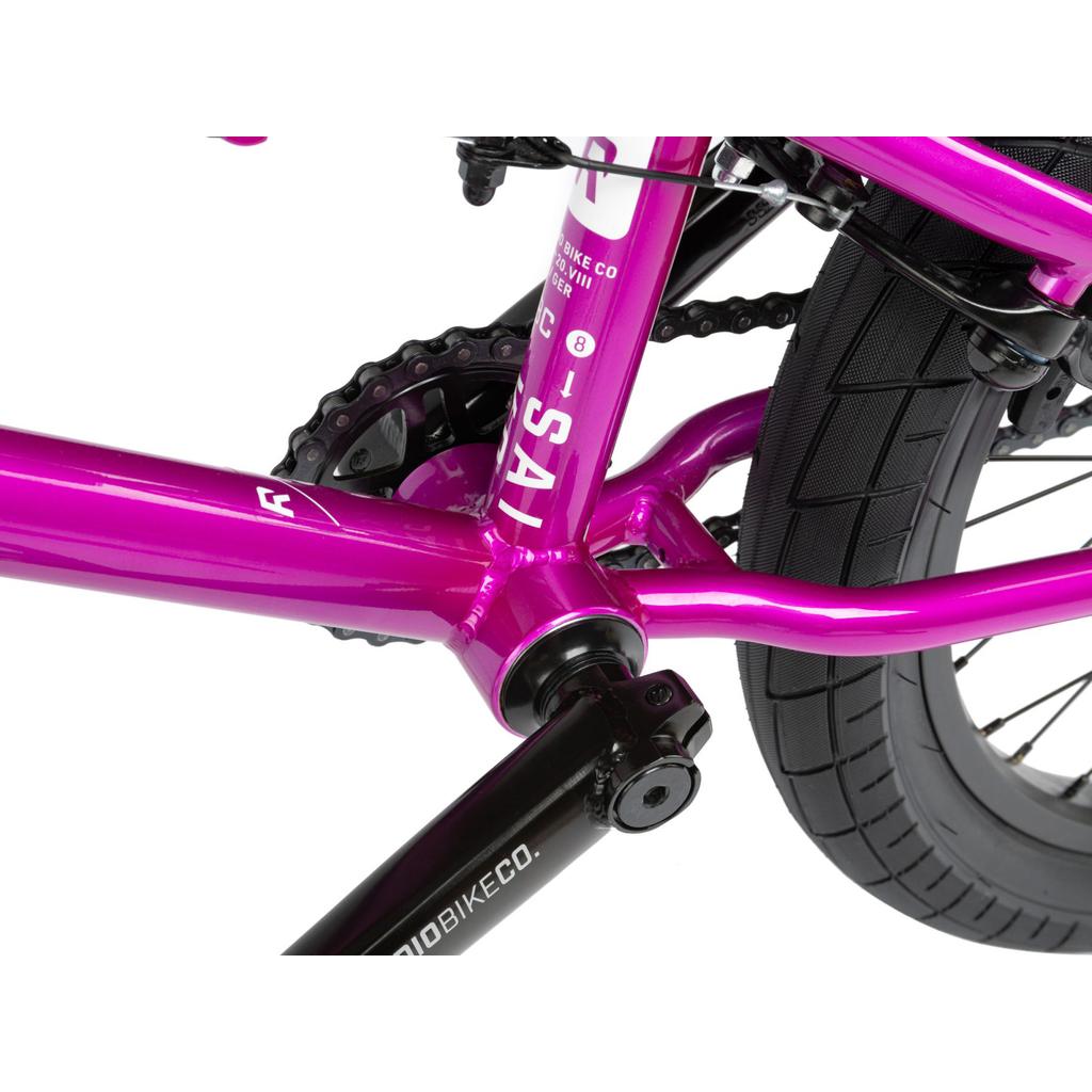 Close-up view of the Radio Saiko 20 Inch Bike in pink, highlighting the crank arm, chainring, Salt Tracer Tyres, chain, and rear wheel tire.