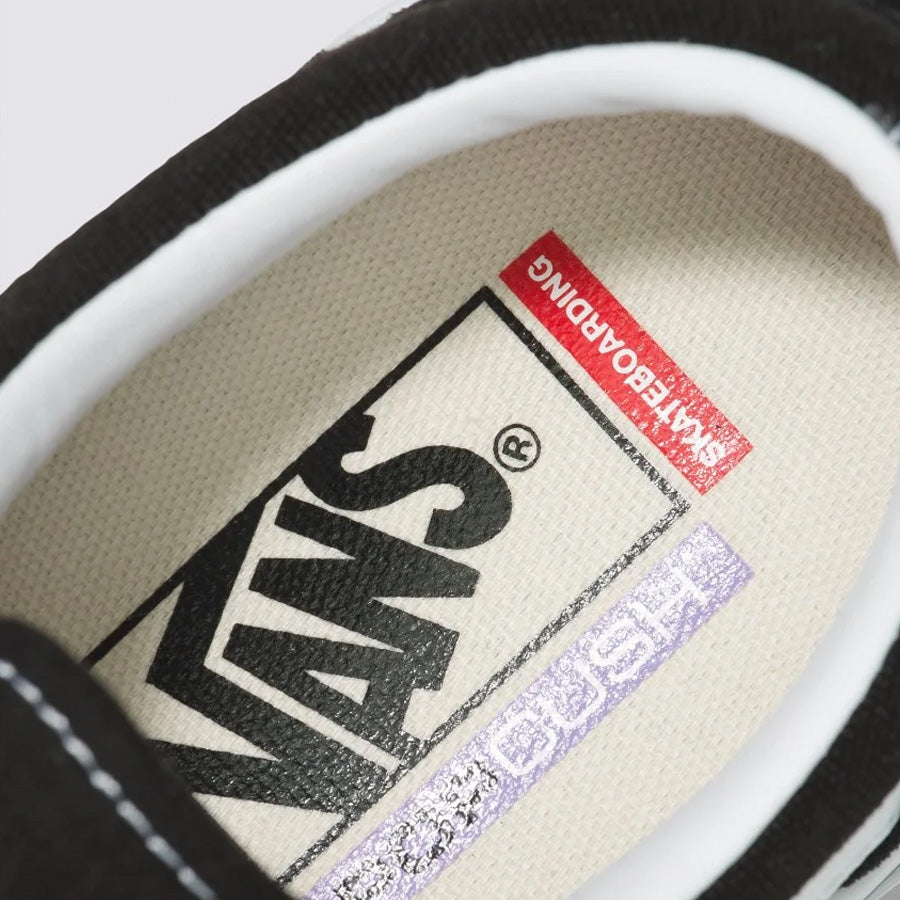 Close-up view of a Vans Skate Old Skool Shoes - Black/White shoe label inside the tongue showing the brand name and logo.