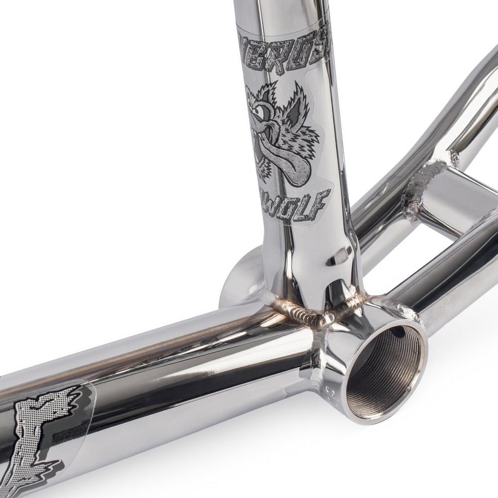 Close-up of the Subrosa Speedwolf V2 Race Frame's shiny Chromoly frame, featuring engraved graphics of a cartoon wolf and "WOLF" on the down tube—ideal for BMX racing fans.