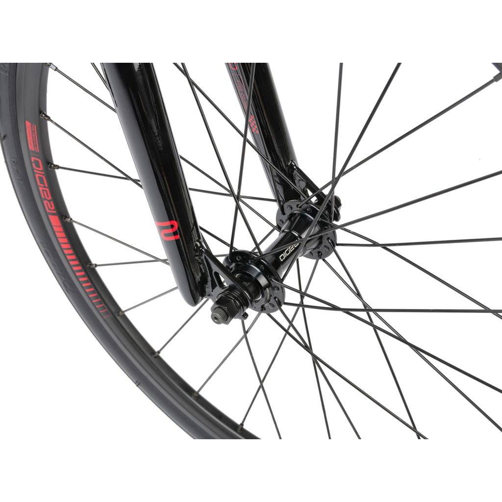 A close up of a black Radio Xenon Junior Bike race wheel with red spokes.