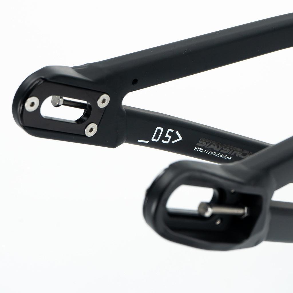 Close-up of the Staystrong V5 Disc Mini Frame’s black 6061 alloy dropout, showing mounting points, disc brake compatibility, and a printed "_05" code.