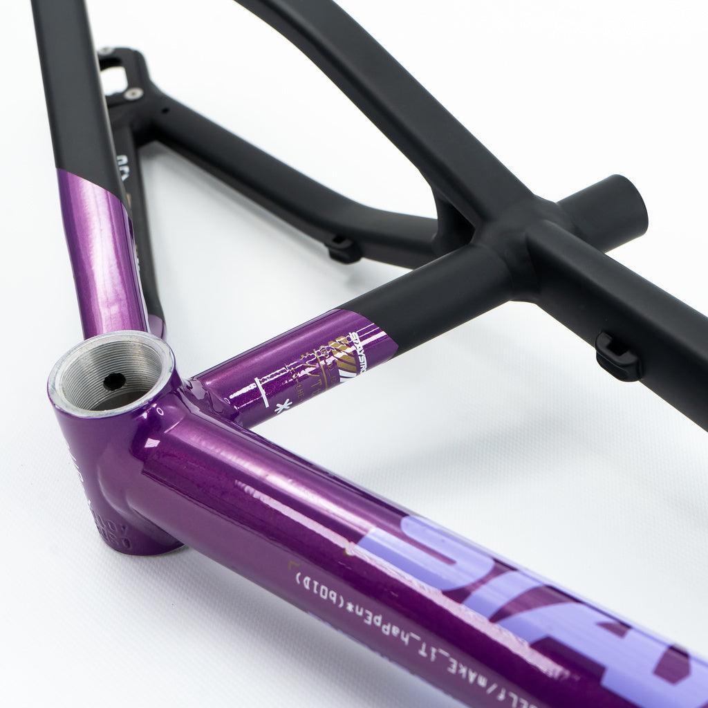 Close-up of a Staystrong V5 Disc Mini Frame, showing its matte black rear triangle and metallic purple 6061 alloy front, photographed against a white background.