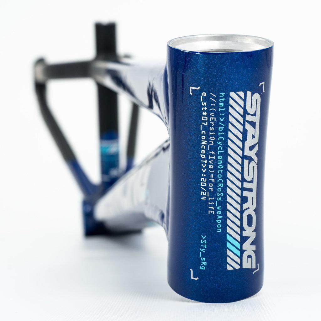 Close-up front view of the Staystrong V5 Disc Junior Frame, featuring blue metallic 6061 alloy tubing, "STAY STRONG" branding, a web address on the head tube, and designed for disc brake compatibility.