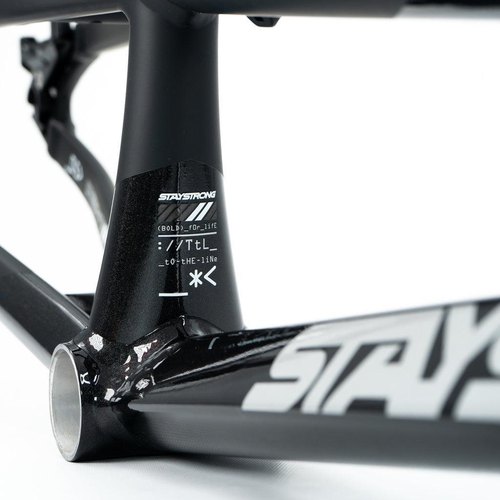 Close-up of the black Staystrong V5 Disc Expert XL Cruiser Frame with "STAY STRONG" branding and technical specs printed on the bottom bracket area.