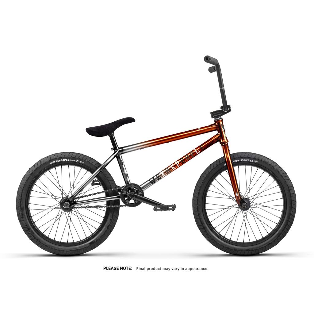 The Wethepeople Justice 20 Inch Bike features black tires, a black seat, and a metallic red-to-silver fade frame. Displayed in profile against a white background.