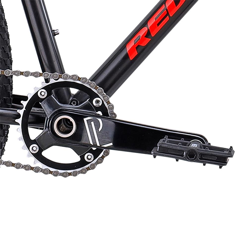 Close-up of a singlespeed 29er crankset, chainring, and pedal on the black and red steel frame of the Redline Monocog 29 Inch Bike.