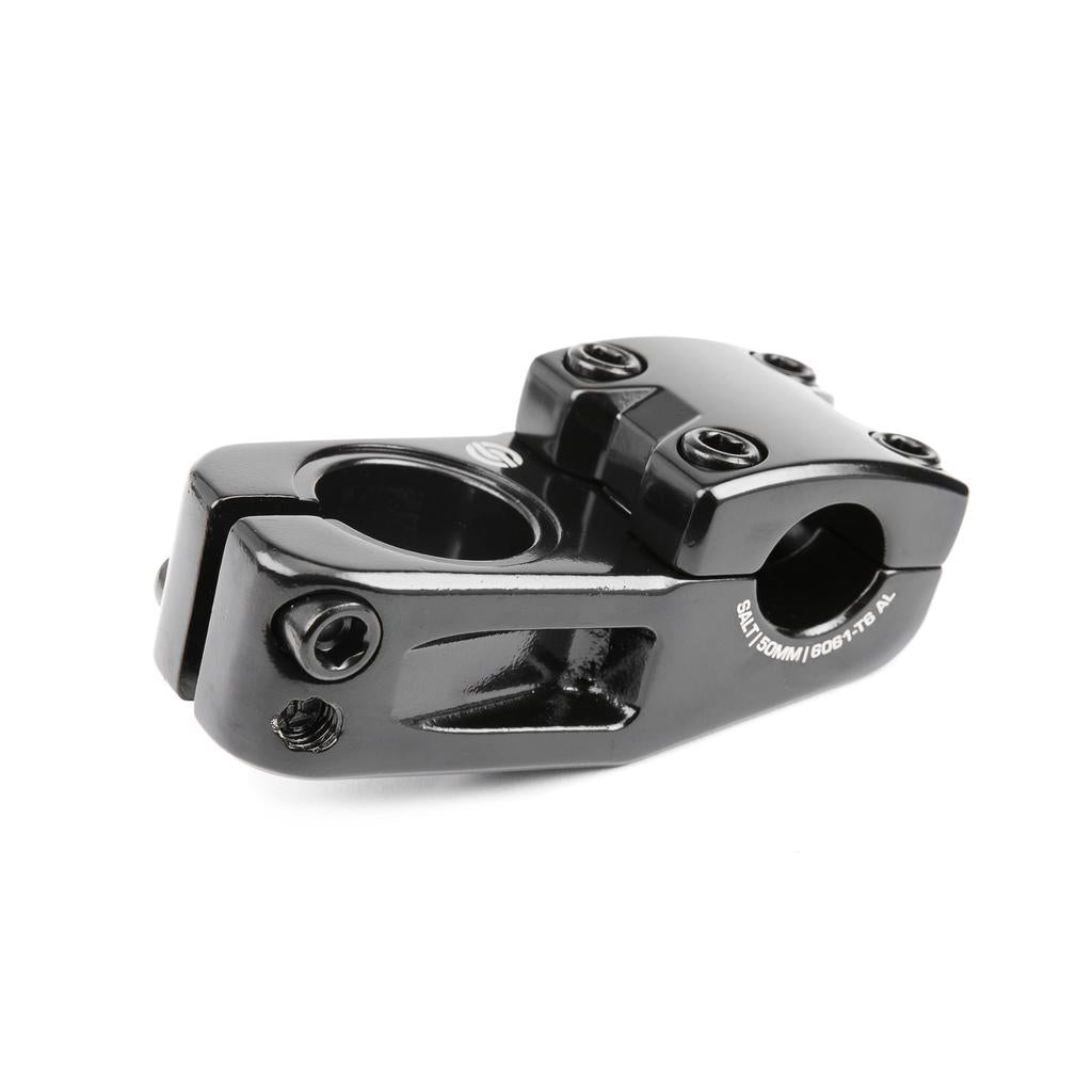 Introducing the Salt Am V2 Top Load Stem (22.2mm Clamp): a black stem precision-crafted from 6061 T6 alloy, featuring a four-bolt faceplate and side clamp design. This top load stem uses shark tooth clamping for a secure grip, making it ideal for attaching handlebars to the steerer tube.