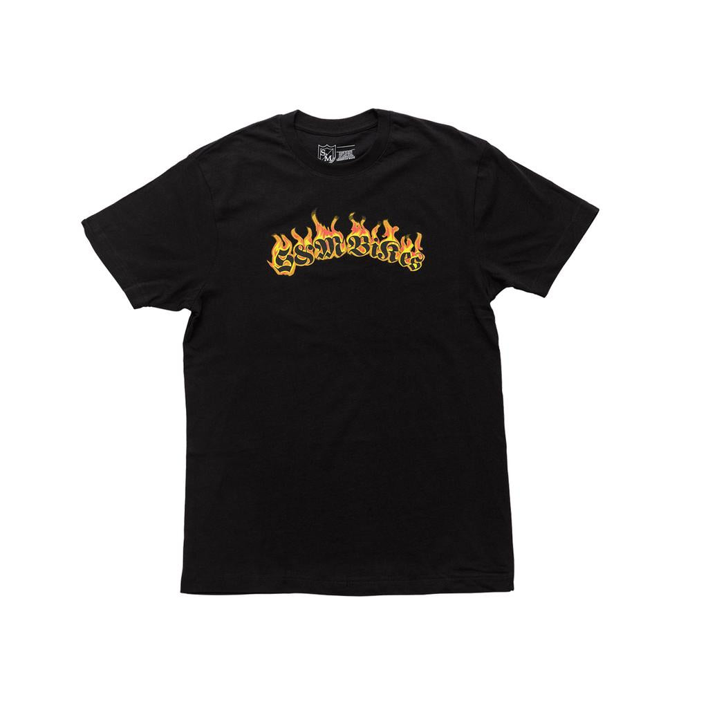 The S&M Old Flames T-Shirt is a black heavyweight 100% cotton tee featuring "Essentials" in yellow flame-style lettering across the chest, inspired by vintage BMX shirt designs.