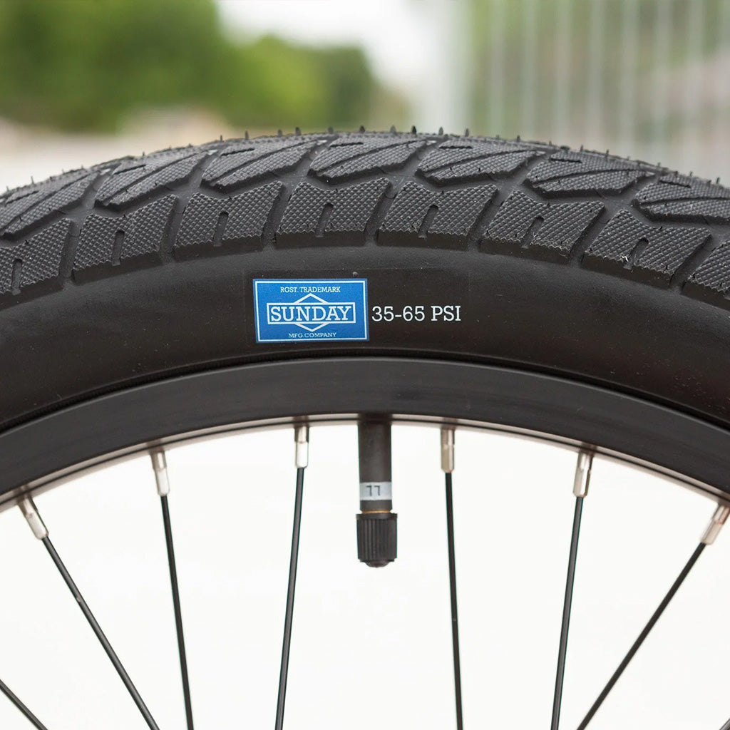 A close up of a BMX tire on a Sunday Blueprint 20 inch Bike.