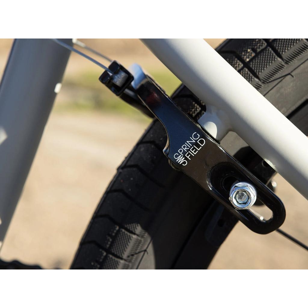 Close-up of the Sunday Model C 24 Inch Bike’s rear wheel with an Odyssey Springfield black brake caliper mounted on its chromoly frame.
