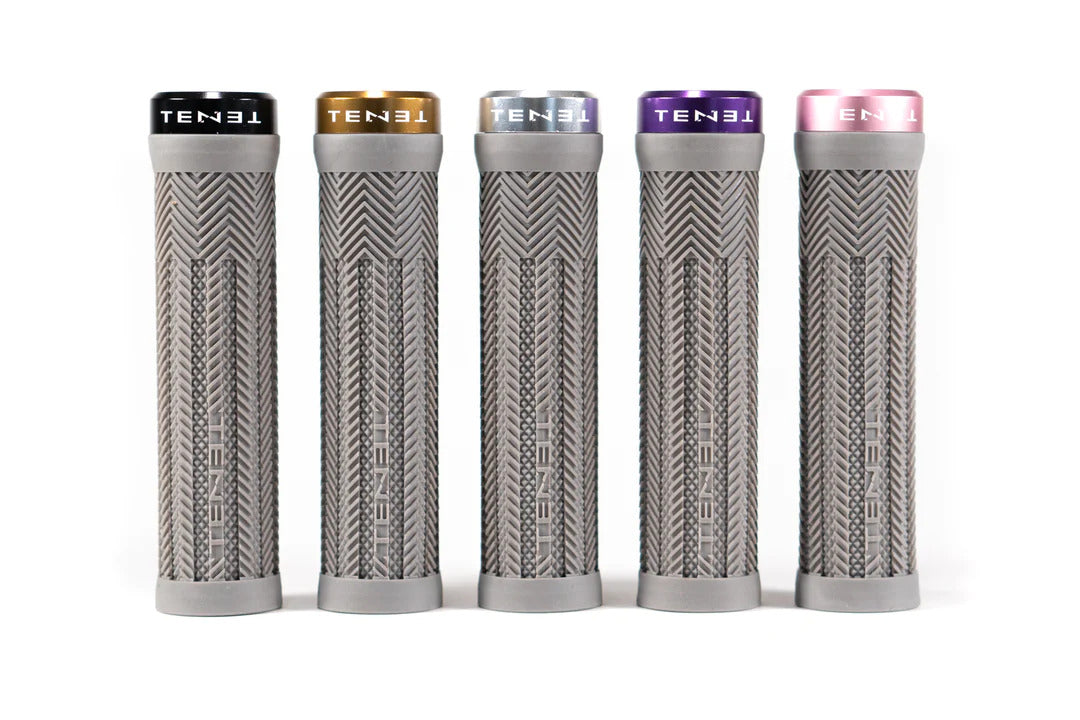 Introducing the Tenet Components - Icon Grip: a set of five grey, cylindrical mountain bike grips featuring textured patterns and topped with individual colored caps—black, gold, silver, purple, and pink. These lock-on grips are crafted from extra soft rubber to deliver superior comfort and control on every ride.