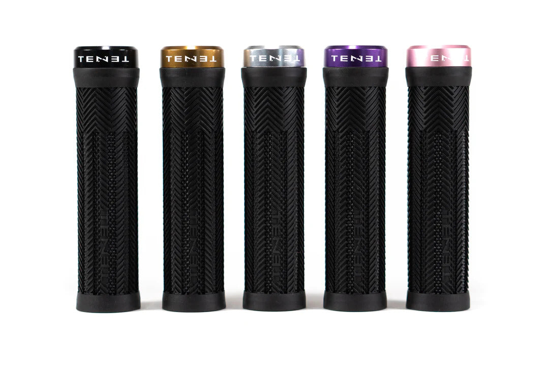 Five Tenet Components Icon Grips in black, each with a textured surface and a distinctively colored metal lock-on end cap in black, gold, silver, purple, and pink. These extra-soft rubber grips offer superior comfort and control for your mountain bike rides.