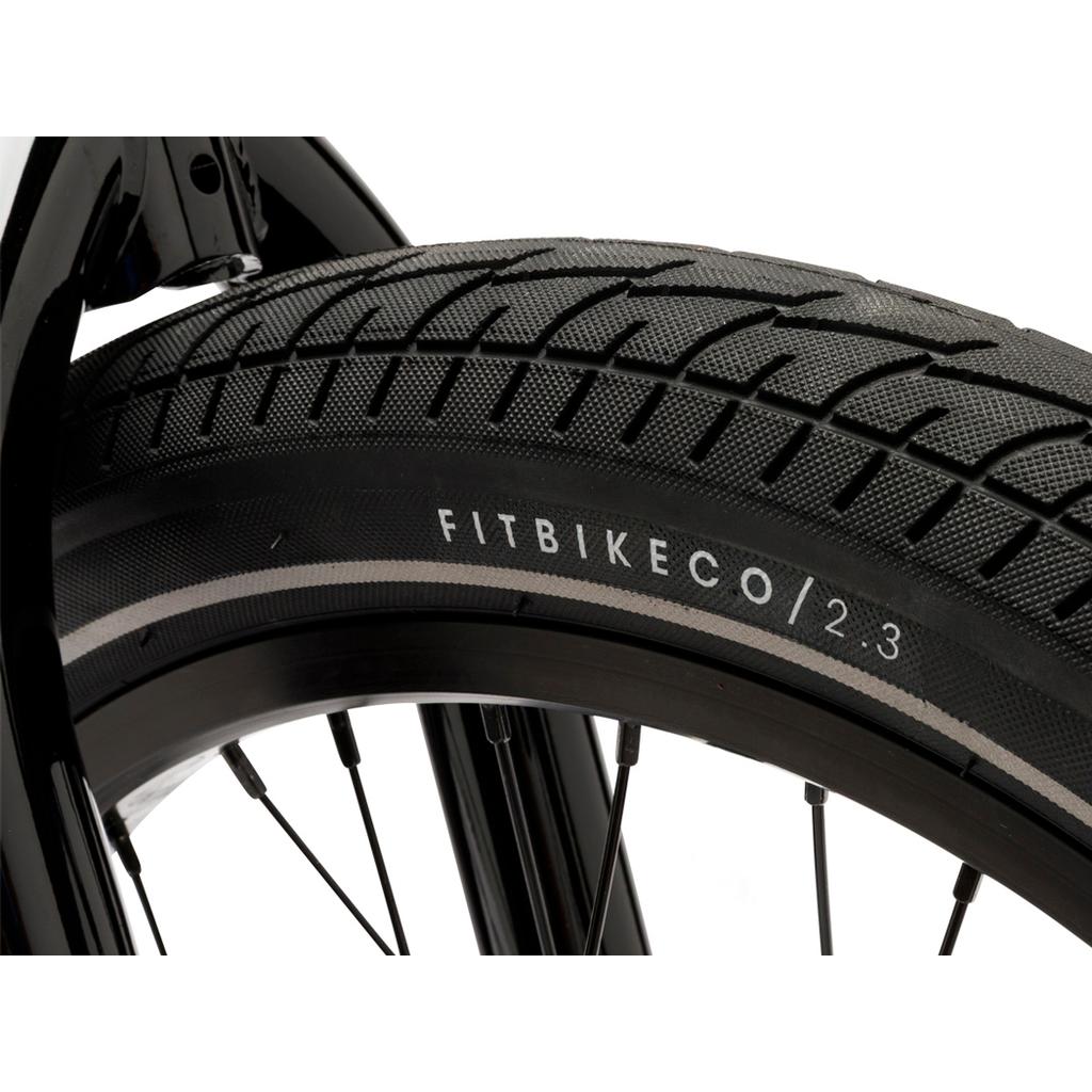 Close-up of a Fit Bike Co Misfit 18 Inch Bike tire mounted on a wheel, with "FITBIKECO/2.3" visible on the sidewall.