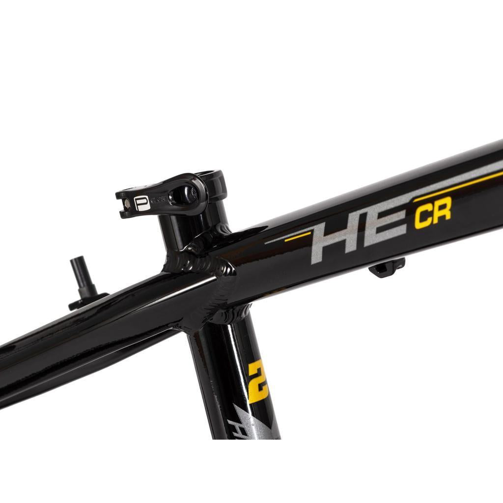 Close-up of the black Radio Raceline Helium Cruiser 24 Frame, hydroformed 6061 alloy, showing the top tube, seat tube, seat post clamp, "HE CR" text with yellow accents; this frame is disc brake compatible.