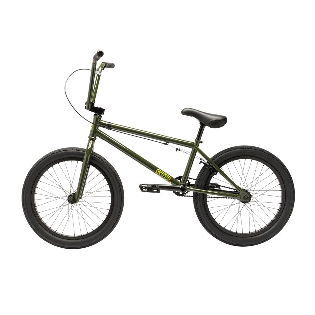 The Fit Bike Co STR 20 Inch Bike (2026) is a green BMX with black tires, a black seat, and a yellow logo on the frame, shown from the side against a white background.