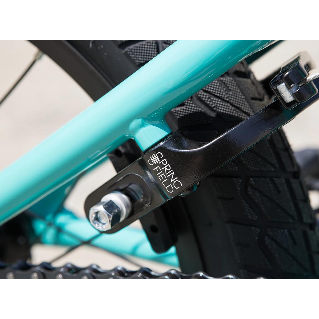 Close-up of the Odyssey Springfield Brakes on the rear of a Sunday Primer 16 Inch Bike (2025) in teal, mounted over a black tire—ideal for pro-level BMX performance.