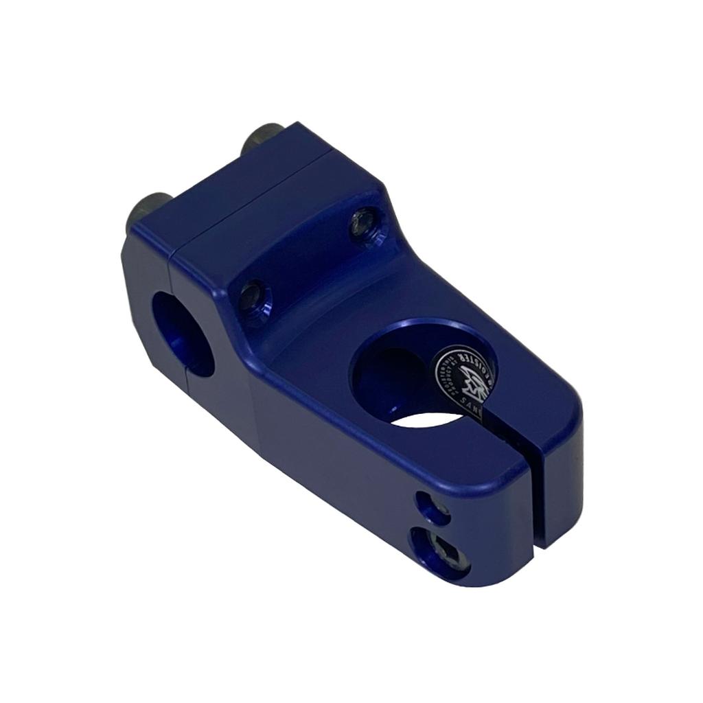 The S&M Shredneck Stem, crafted from 6061-T6 aluminum in matte blue with multiple bolt holes and a central opening, is displayed at an angle on a white background.