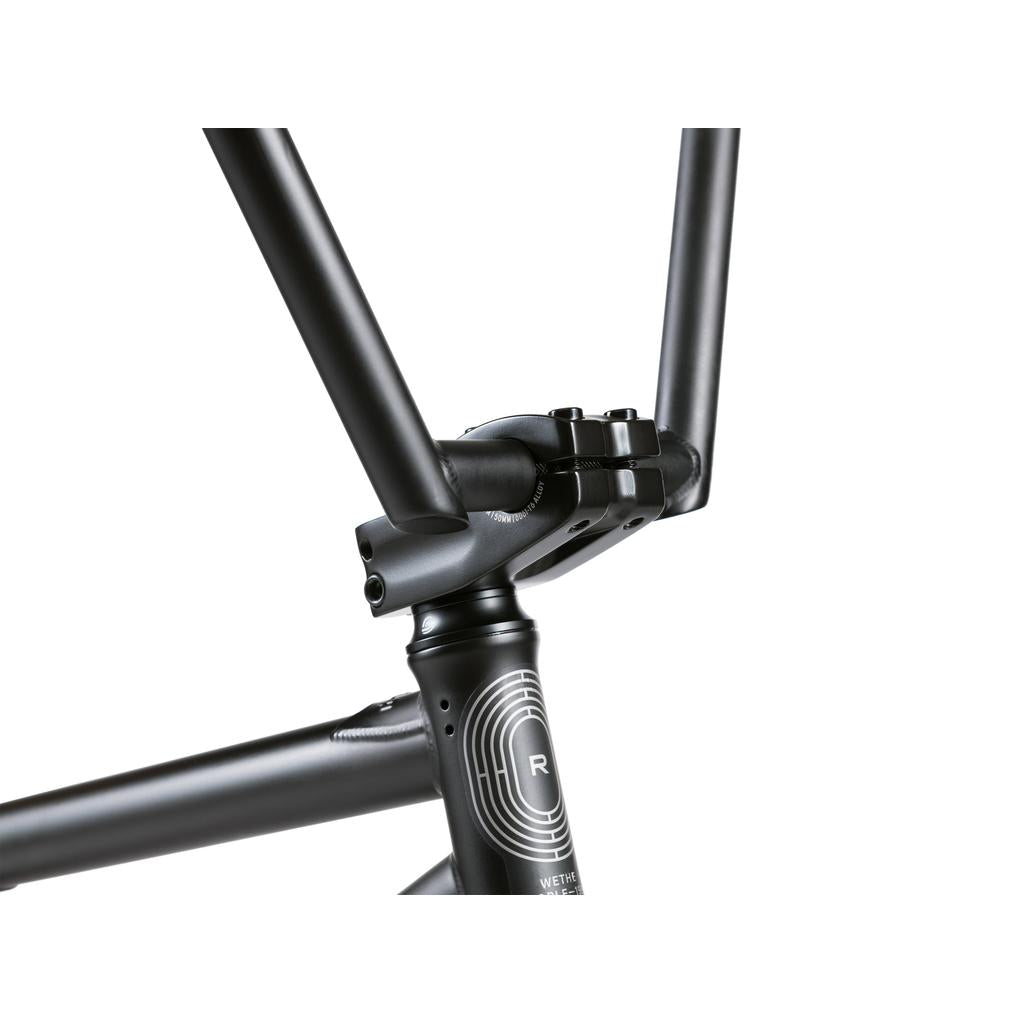 Close-up of the Wethepeople Reason Shift 20 Inch Bike's matte black full chromoly frame, highlighting the seat tube, top tube, clamp area with branding, and circular logo—ideal for a premium BMX experience.