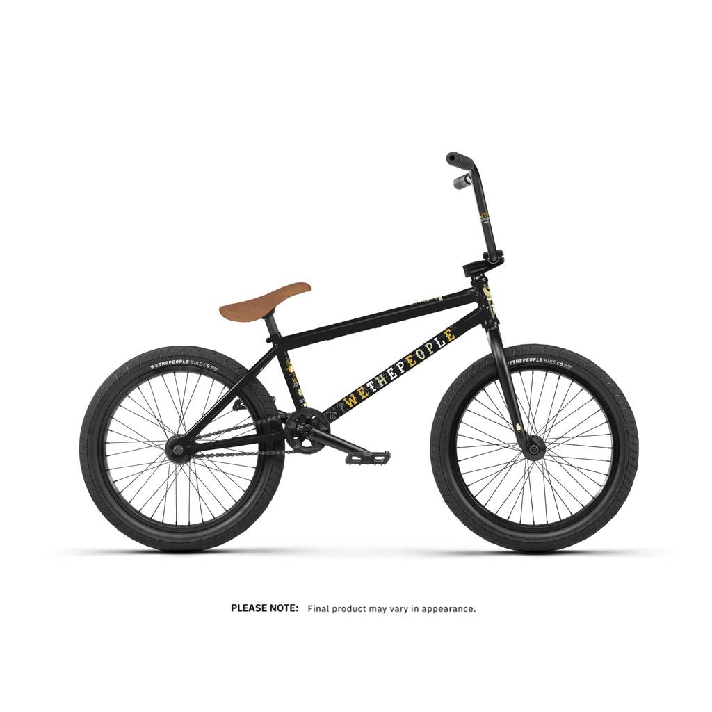A Wethepeople Justice 20 Inch Bike, featuring a black frame with "WETHEPEOPLE" branding and a brown seat, is displayed on a white background. Final appearance of the BMX bike may vary.