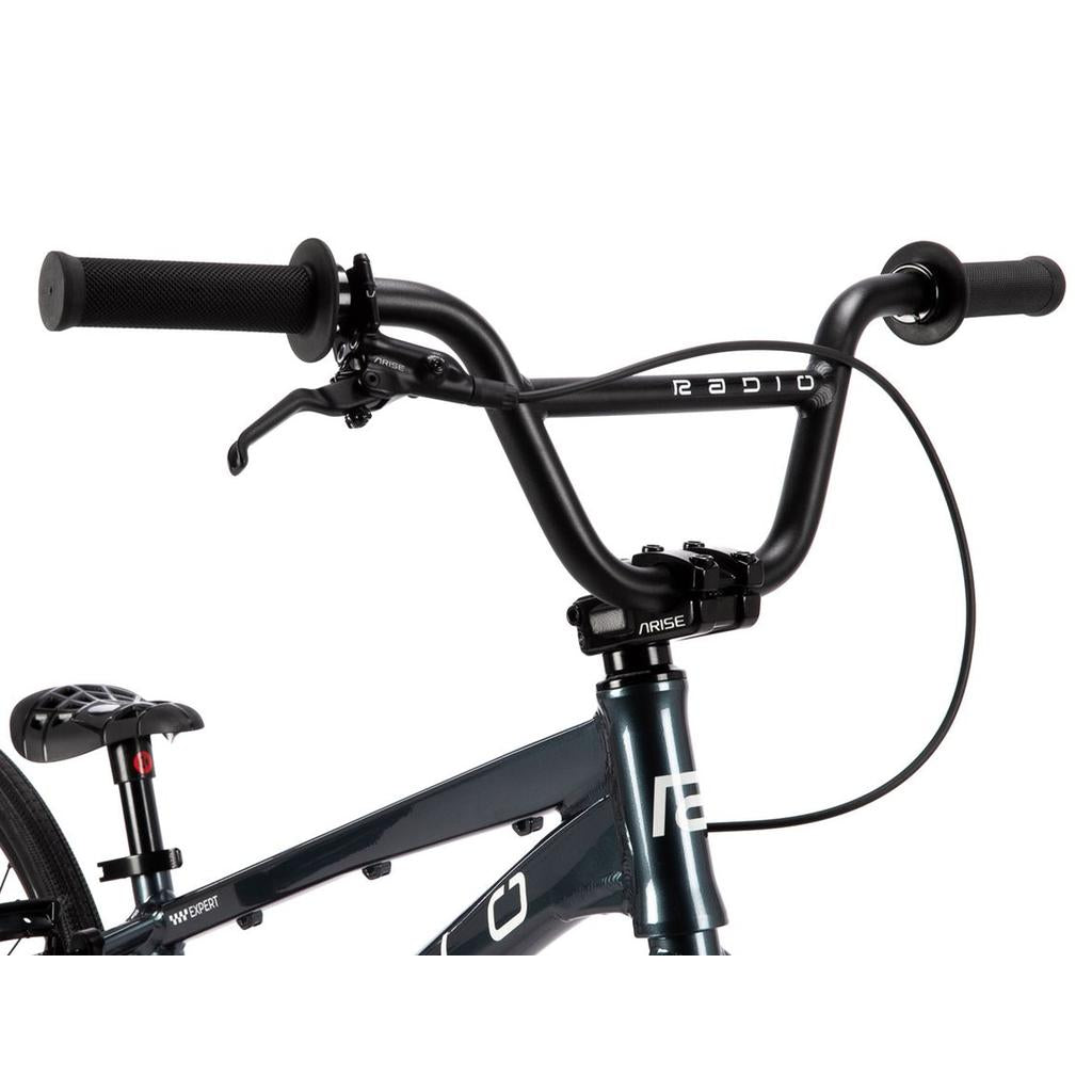 Close-up of the Radio Xenon Expert Disc 20 Inch Bike’s front end, highlighting the handlebars with the “Radio” branding, brake lever, top of the front fork, and part of the seat. Its lightweight alloy frame ensures optimal performance on the track.