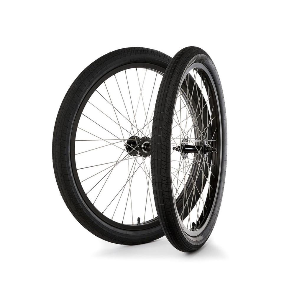 The S&M Covid 26 Inch Wheel Set features two black bicycle wheels with spokes and double wall 26" rims, shown upright side-by-side against a white background.