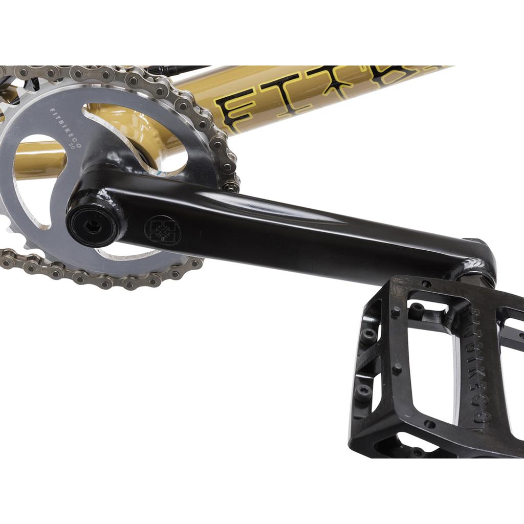 Close-up of the crank arm, chainring, and pedal on the Fit Bike Co Nightwolf 20 Inch Bike, featuring a gold and black frame with trail geometry.