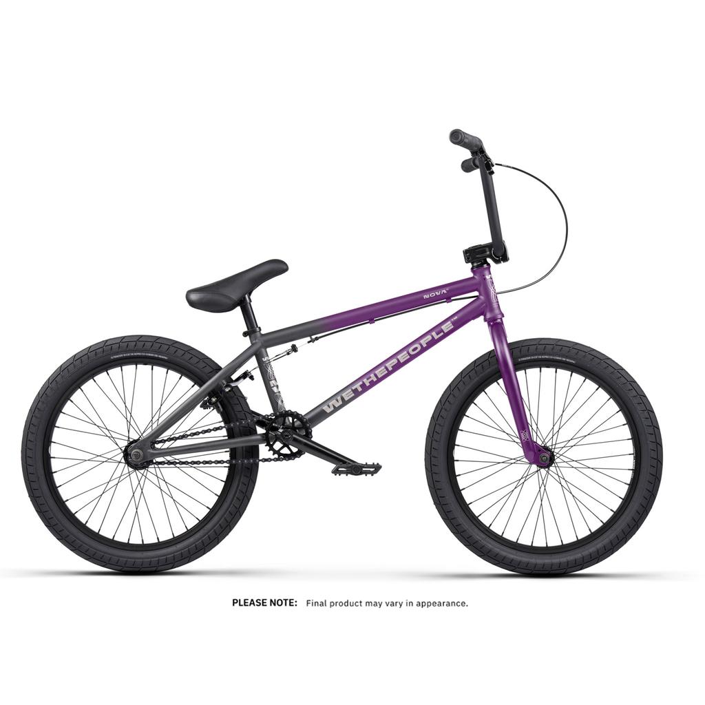 The Wethepeople Nova 20 Inch Bike, shown on a white background, features a purple and black frame, thick tires, straight handlebars, Salt Rookie Tubular Chromoly Cranks, and a padded seat.