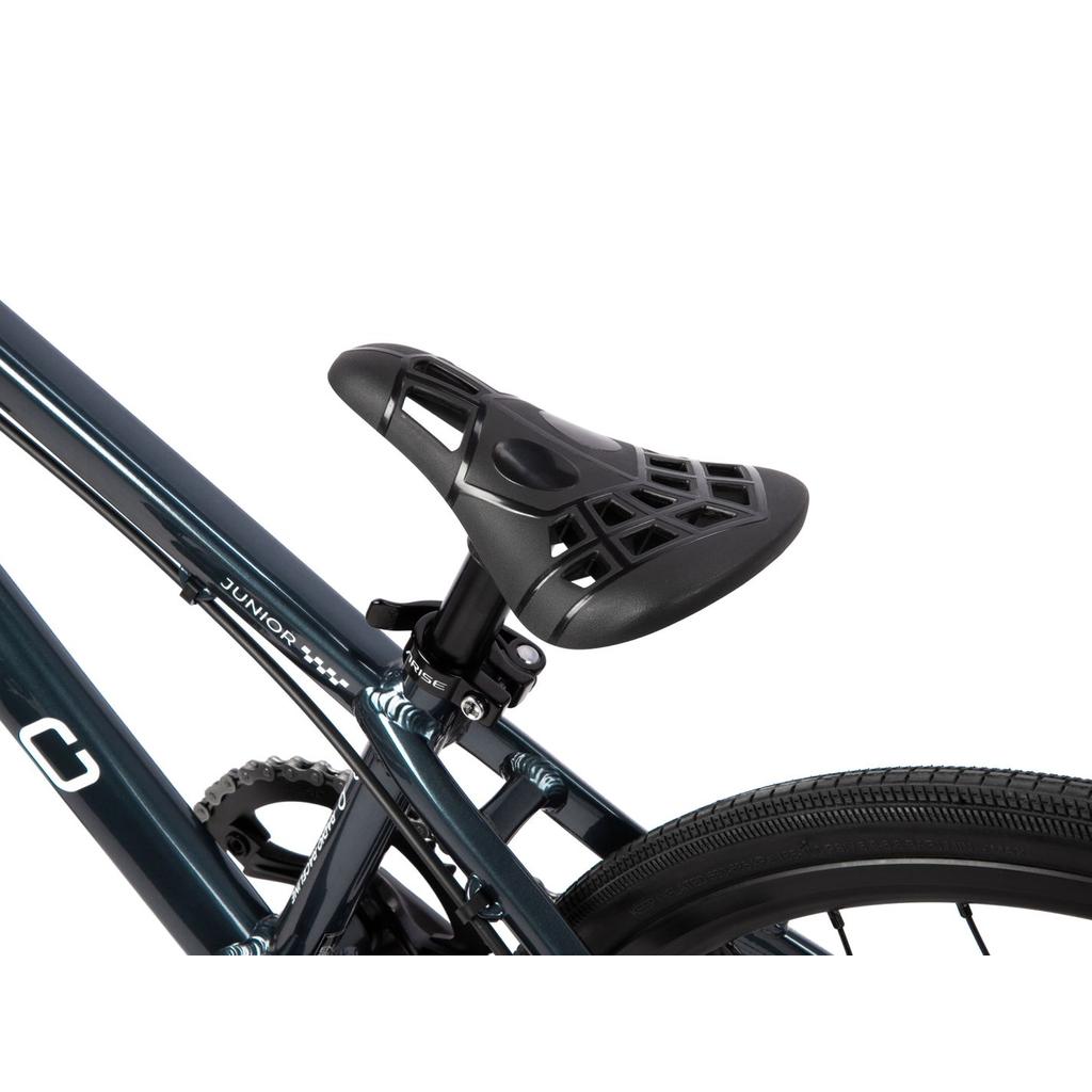 Close-up of a black saddle with a cutout design, mounted on the blue hydroformed 6061-T6 alloy frame of the Radio Xenon Junior Disc 20 Inch Bike, showing part of the rear wheel and Tioga Power Block tyres.