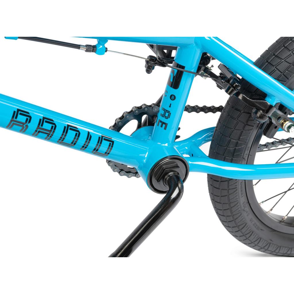 Close-up of the Radio Revo 16 Inch Bike in blue, highlighting the frame, rear wheel, chain, pedals, and brake cables—an ideal outdoor bicycle for kids.