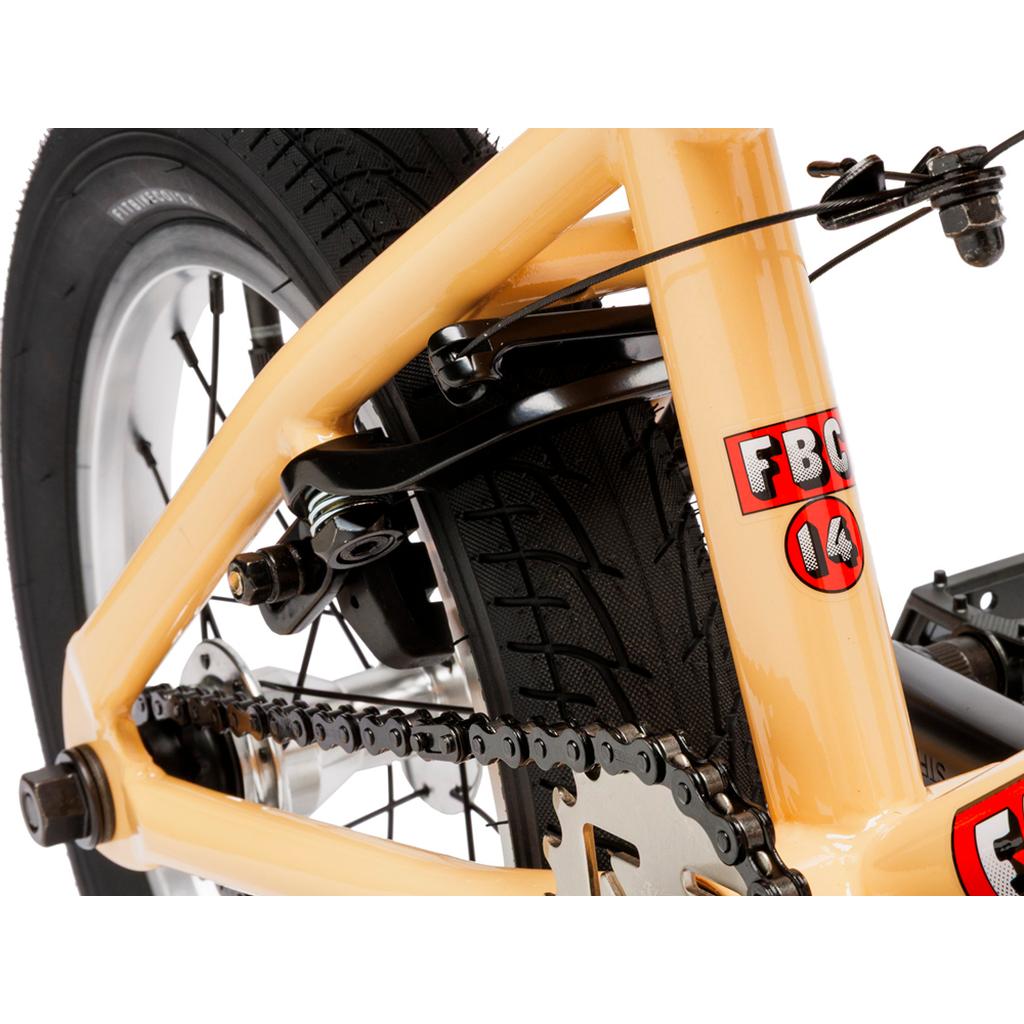 Close-up of the rear wheel, chain, brake, and frame of a beige Fit Bike Co Misfit 14 Inch Bike for kids, with "FBC 14" stickers visible.