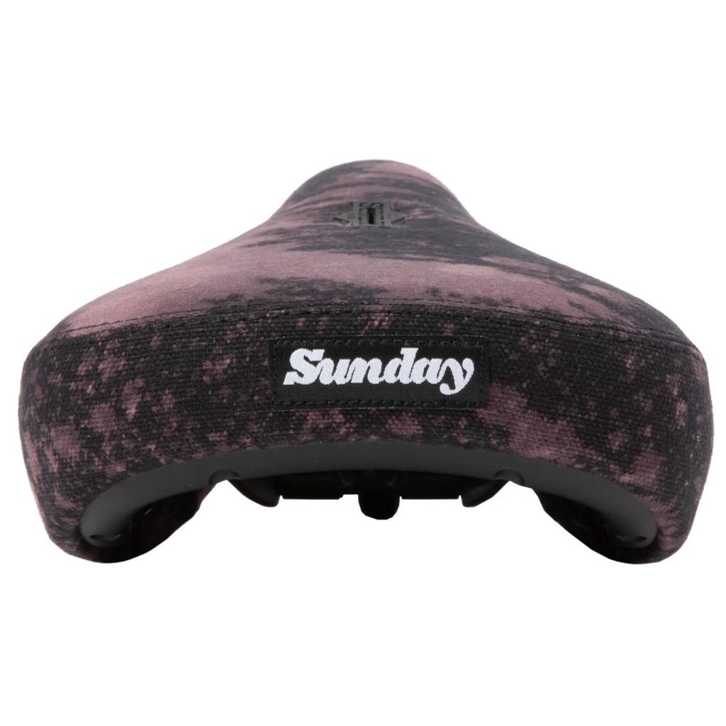 Close-up of the Sunday Pivotal Seat (Brett Silva Signature) with a black and pink marbled pattern and "Sunday" printed on the back—a unique design inspired by Brett Silva.