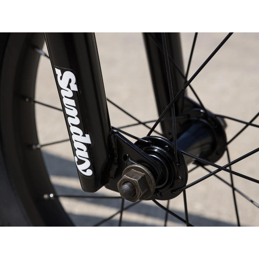 Close-up of the black front wheel hub and spokes on the Sunday Primer 16 Inch Bike (2025), with "Sunday" in white lettering on the fork, showcasing pro-level BMX features.