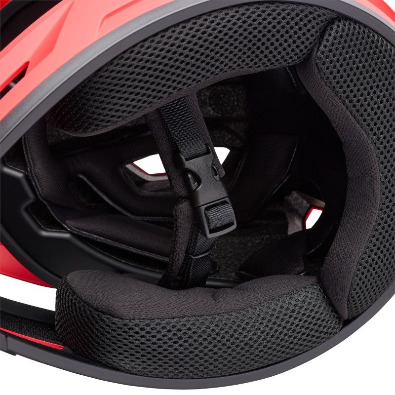 Close-up view of the interior padding and chin strap of the Bell Sanction 2 Red helmet, featuring mesh lining and buckle.